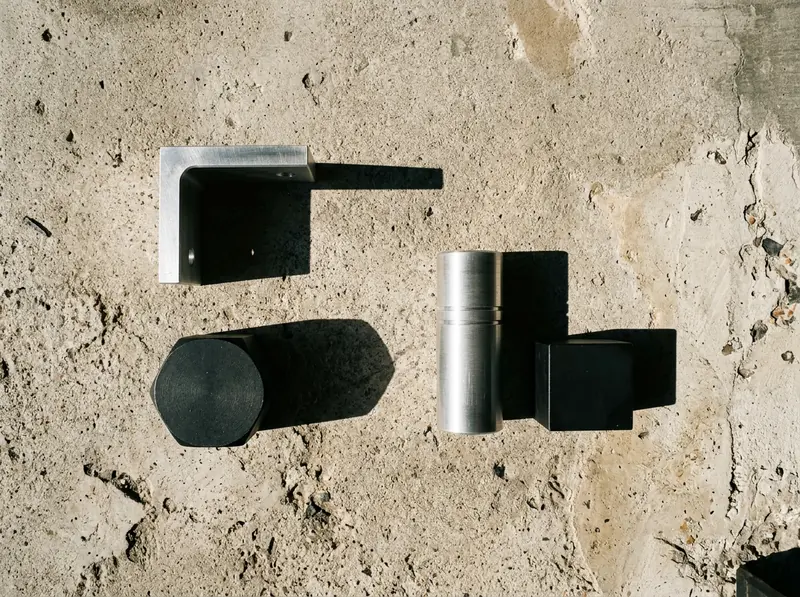A work surface shot from directly above, metal components in raking light